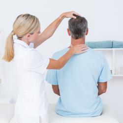 Osteopath assessing posture